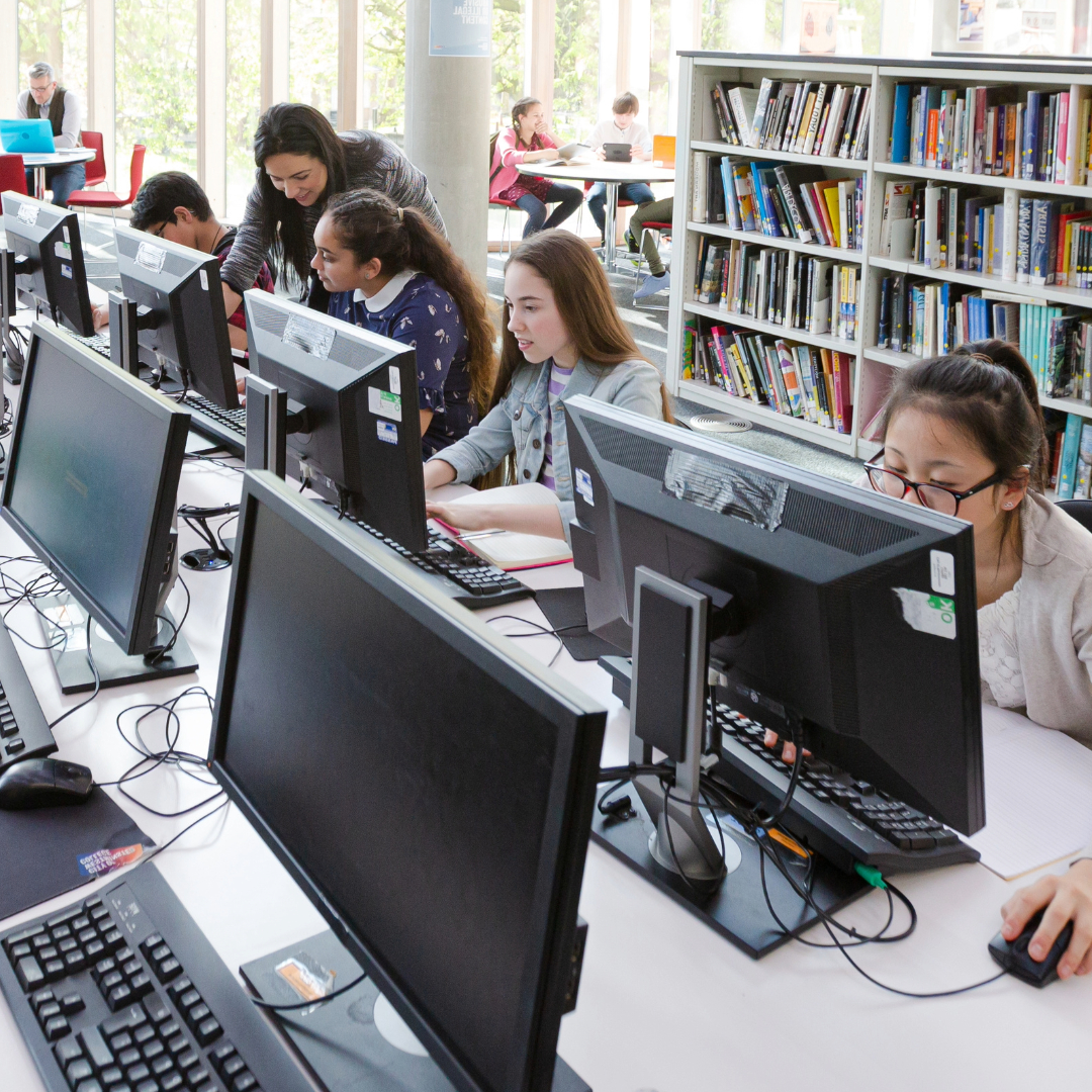 Students in a library looking at computers.